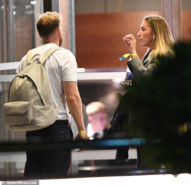 The couple looked serious as they chatted outside the afterparty