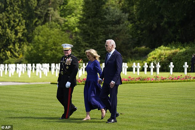 President Biden and First Lady Jill Biden walk with Major General Robert Sofge Jr.  as they attend a wreath-laying ceremony at the Aisne-Marne American Cemetery to honor fallen soldiers of World War I on June 9, 2024