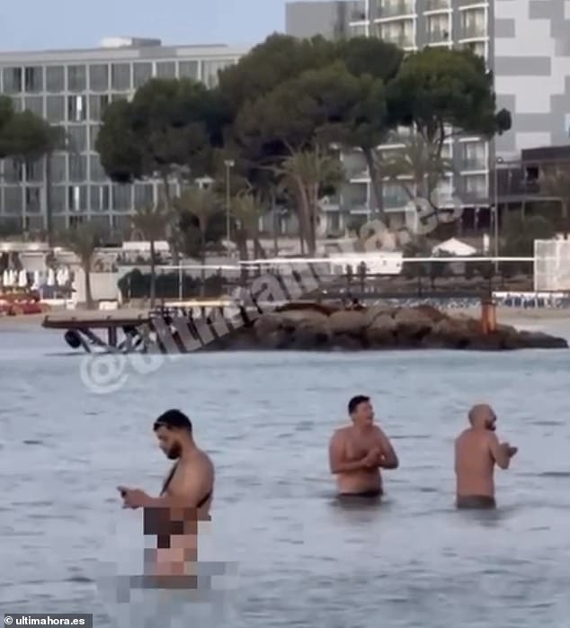 A group of men are seen naked in the sea in Magaluf