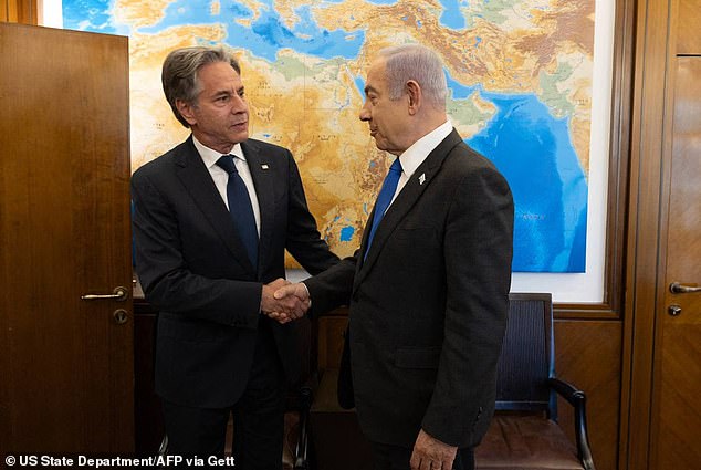 In a handout photo on Monday, Secretary of State Antony Blinken (left) greets Israeli Prime Minister Benjamin Netanyahu (right)