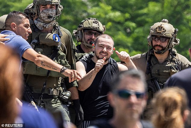 Meir is seen giving the thumbs up shortly after his release while surrounded by IDF soldiers