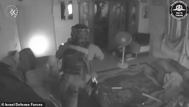 In the video, the troops storm into the apartment, searching for targets before bursting into a bedroom where three men can be seen crouching.