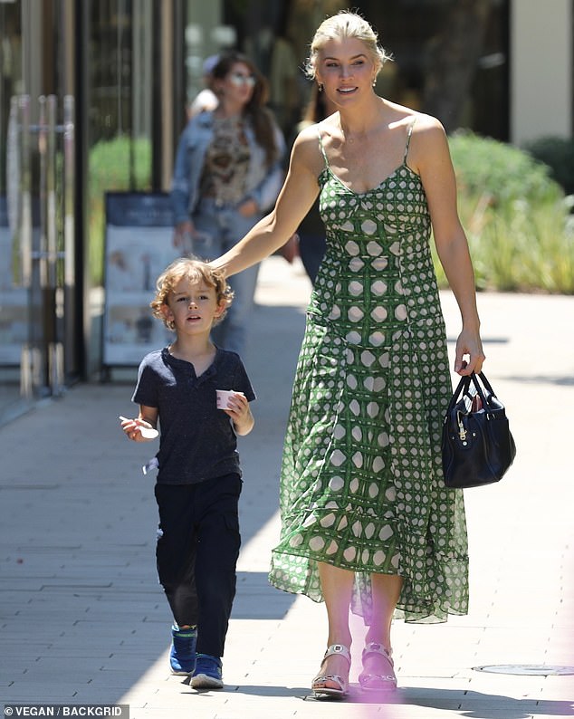 The 42-year-old talk show host wore a sleeveless green dress by Misa of Los Angeles along with white open-toed heels for her outing with Elvis in the Encino area