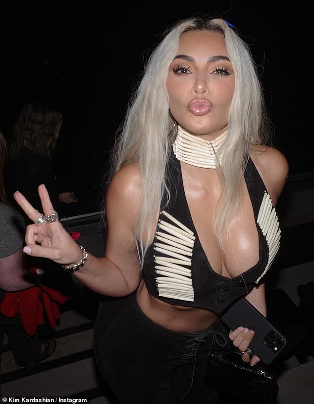 Kim struck her favorite pose: a peace sign and a kissy face