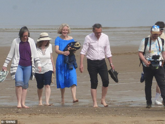 Dr.  Mosley pictured with his wife Clare during filming in Colwyn Bay, Wales, on May 10, just weeks before his death