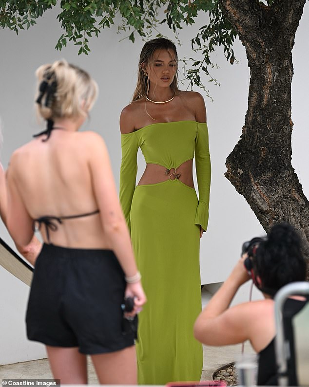 She switched it up for an evening look and opted for a green long-sleeved maxi dress from Bardot