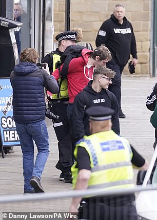 He is then led away by police after the shocking incident in South Yorkshire this morning