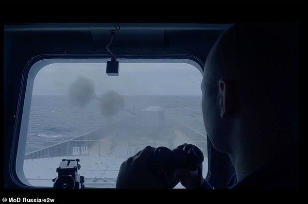 A Russian sailor looks out a window as the Russian frigate Admiral Gorshkov uses its weapons for the first time during a naval exercise, in footage released by the Russian Ministry of Defense
