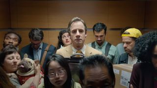 A man standing in an elevator wearing AirPods