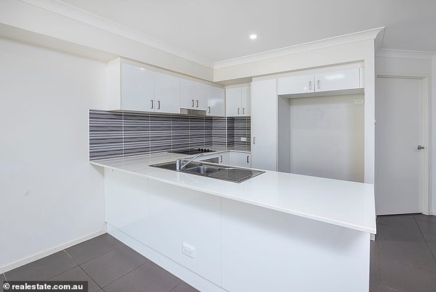 The house has a modern kitchen with stainless steel appliances, including a dishwasher