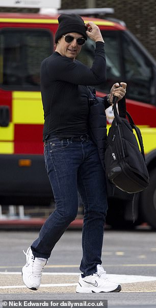 Feeling warm, Tom decided to carry his navy blue padded jacket in one hand and strolled past an ambulance