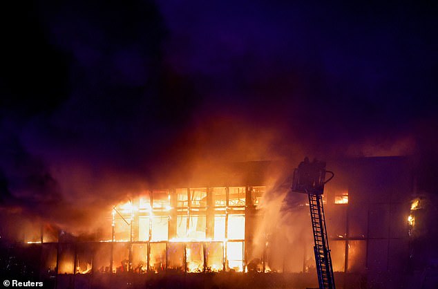 Rescue workers try to extinguish the fire at the burning Crocus City Hall concert hall after a shooting incident, outside Moscow, Russia, March 22, 2024