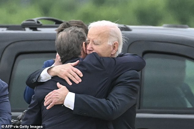 U.S. President Joe Biden hugs his son Hunter Biden upon arrival at the Delaware Air National Guard Base in New Castle, Delaware, on June 11, 2024, hours after Hunter's gun conviction