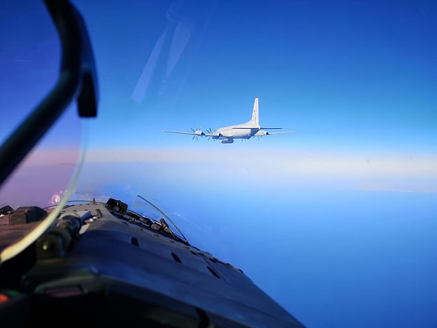 A Russian aircraft is seen from the cockpit of a NATO fighter jet on its way to intercept an Ilyushin-IL20M spy plane