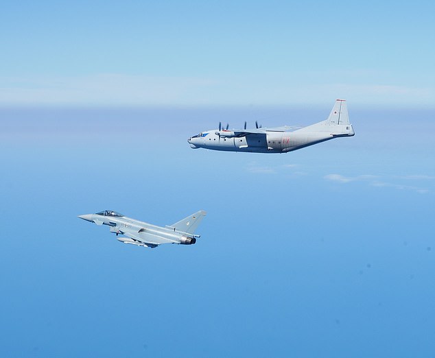 A Eurofighter Typhoon of the German Luftwaffe flanks a Russian Antonov-AN12 cargo plane over the Baltic Sea