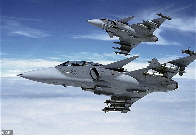 In the photo: two JAS-39 Gripen fighter planes of the Swedish Air Force in close formation.  Sweden will bring state-of-the-art submarines and a fleet of highly capable Gripen fighter jets to NATO forces (File)