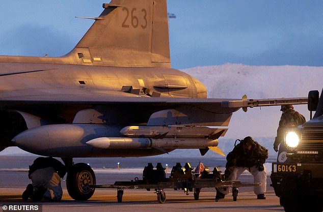 A Swedish flight crew prepares a JAS Gripen fighter jet for takeoff at Kallax Air Base, Sweden, March 4, 2024