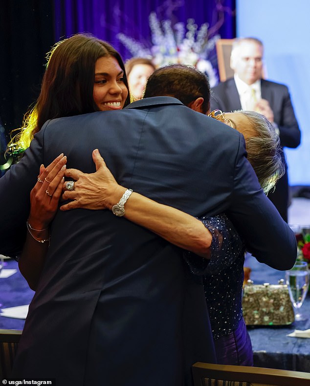 Woods pulled his mother and daughter Sam into a tight hug after leaving the stage