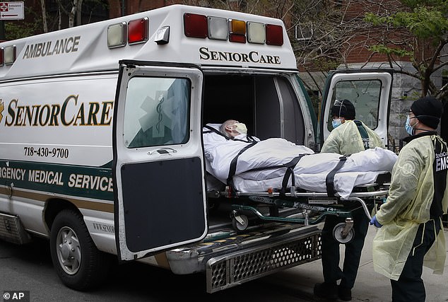 a patient is loaded into an ambulance by medical responders outside the Cobble Hill Health Center in the Brooklyn borough of New York.