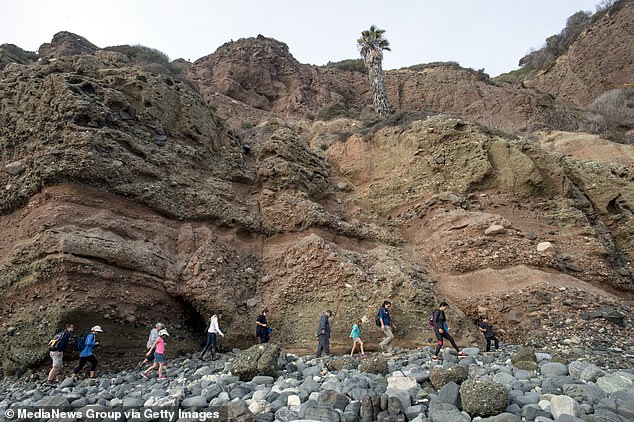 Visitors hike to the tide pools in Dana Point, California