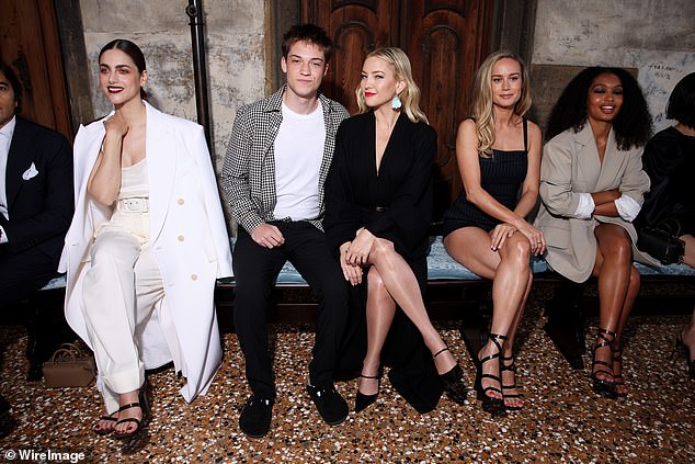 The movie star cut a typically elegant figure in a long-sleeved black dress with a thigh-high leg slit (L-R Miriam Leone, Ryder, Kate, Brie Larson and Yara Shahidi)