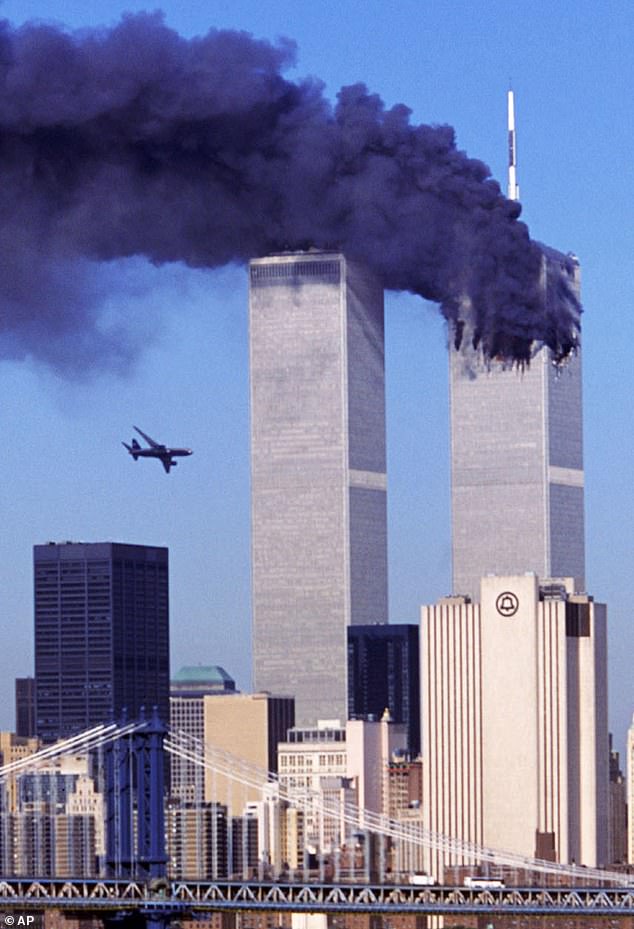 The North Tower of the World Trade Center burns after being struck by hijacked American Airlines Flight 11;  hijacked United Airlines Flight 175 approaching the South Tower of the World Trade Center on September 11, 2001