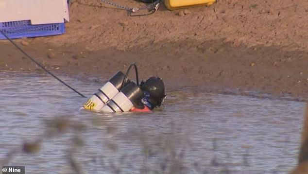 Searchers, including specialist divers (pictured), also found several other items during their search in Buninyong, western Victoria on May 29.