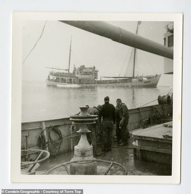 In this photo taken by one of her crew, Quest can be seen sinking into the water after being crushed by sea ice