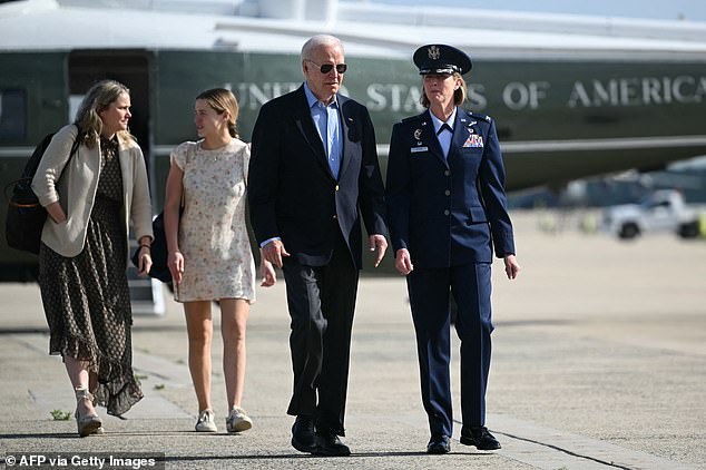 President Joe Biden, with White House Deputy Chief of Staff Annie Tomasini (left), and granddaughter Finnegan Biden (second from left), is welcomed by Air Force Col. Angela Ochoa (right) at Joint Base Andrews