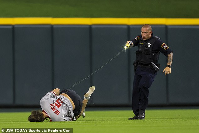 A police officer tased a Cincinnati Reds fan after the fan ran onto the field on Wednesday