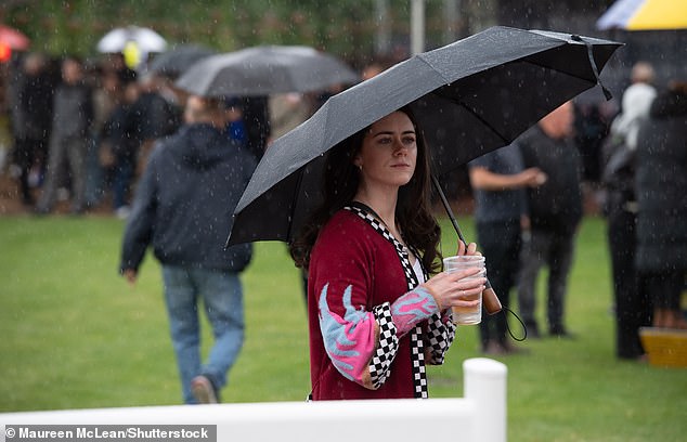 A drizzly June: punters are pictured seeing rain at the Royal Windsor Racecourse in Berkshire, June 11, 2024