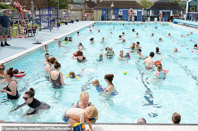 The Met Office says Britain had its warmest May and warmest spring on record, despite being 'wet and dull'.  Crowds enjoy the warm weather at a swimming pool in Hathersage, Derbyshire, England on May 10, 2024