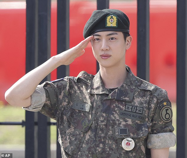 Jin is seen here saluting after being discharged from the base in the north of the country