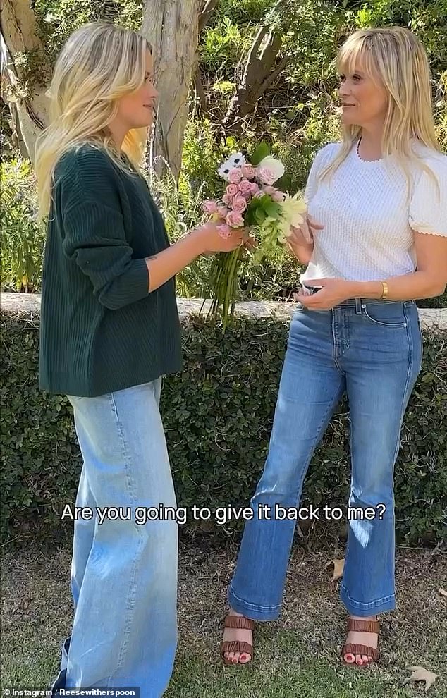 The producer and Ava pass a bouquet of flowers back and forth