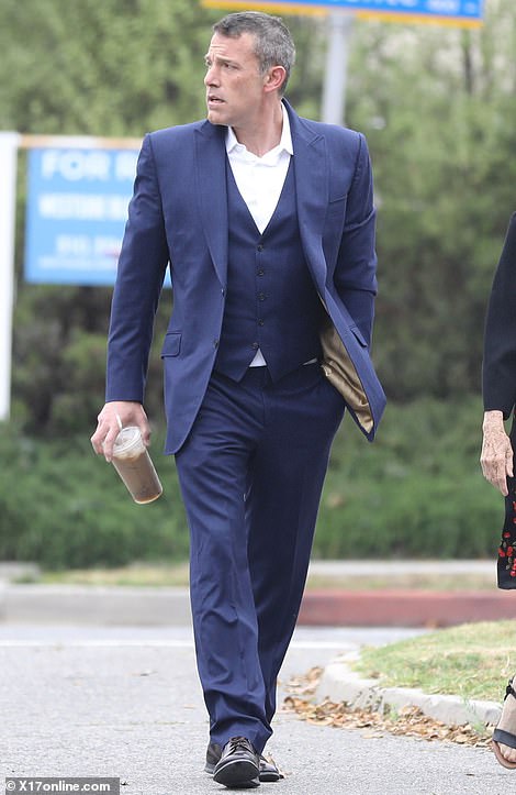 Affleck had a tense look on his face as he carried an iced coffee