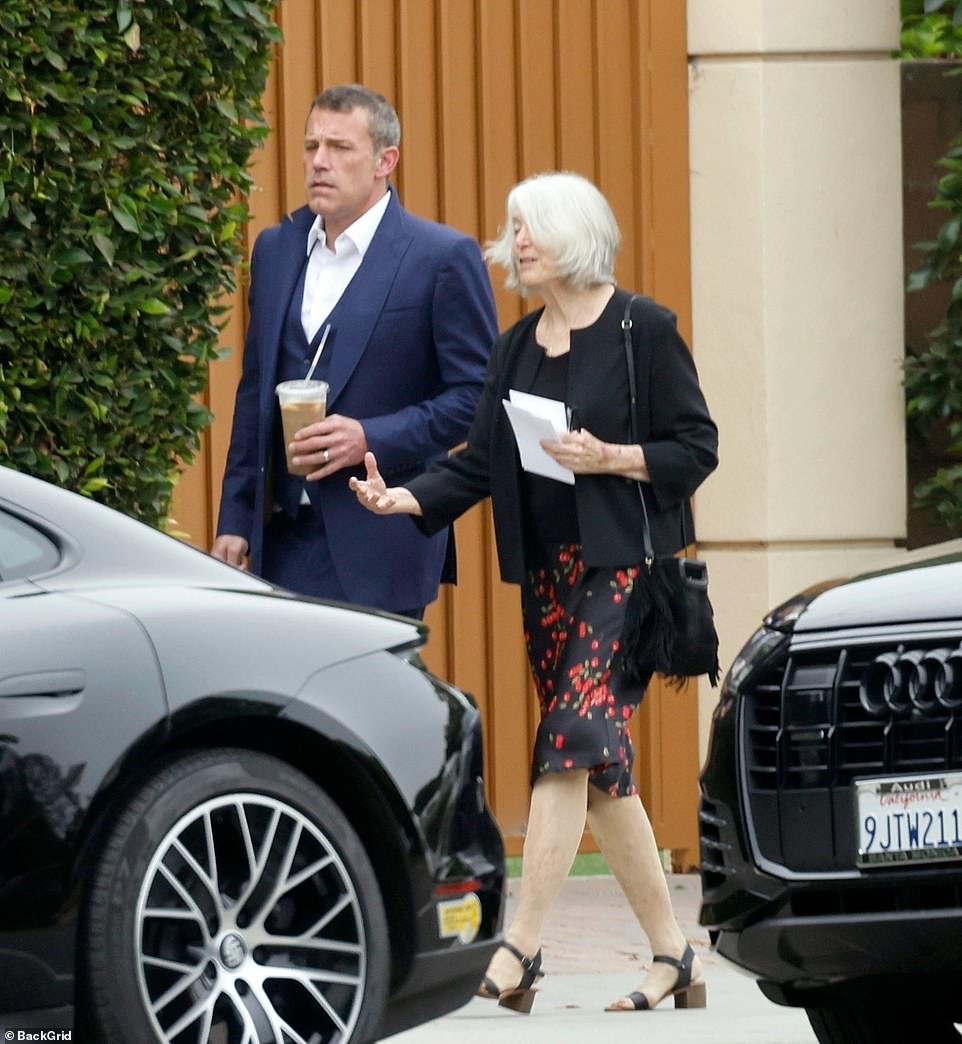 The Argo star showed off his gold wedding ring from Jennifer on his wedding hand as she walked with his mother, who wore a black skirt with red flowers