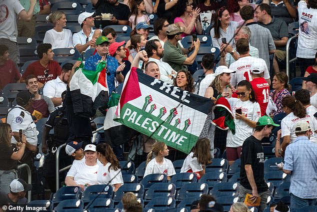 In the stands, pro-Palestinian protesters also unfurled flags and chanted, while others booed