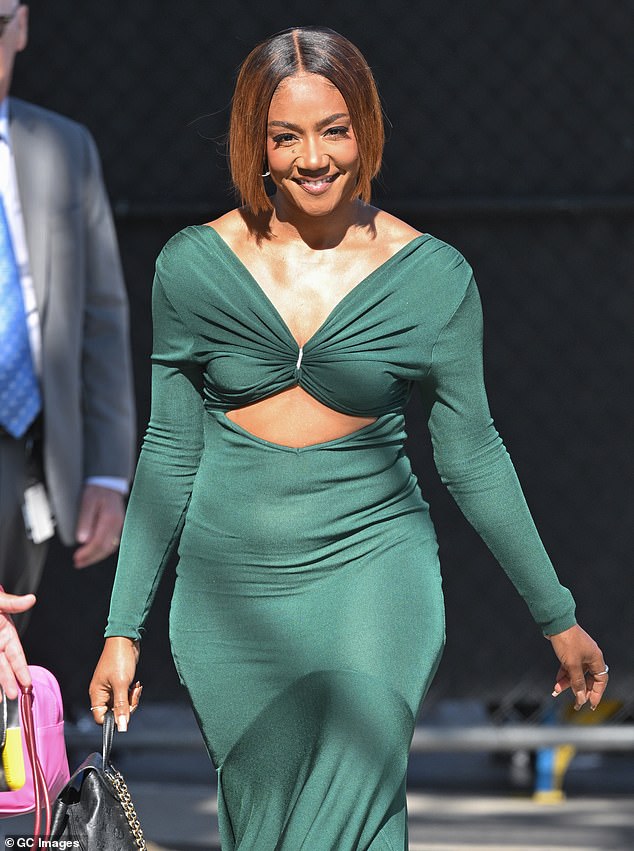 The comedian turned singer, 44, showed off her toned stomach in a fitted dark green dress with cutouts