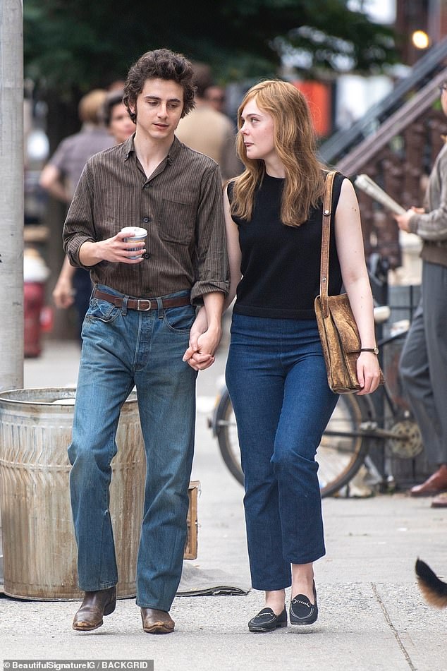 Timothée was dressed in a brown striped button-down shirt with rolled-up sleeves.  He tucked him into relaxed-fit jeans with a narrow brown belt and added a cool pair of dark brown worn cowboy boots.