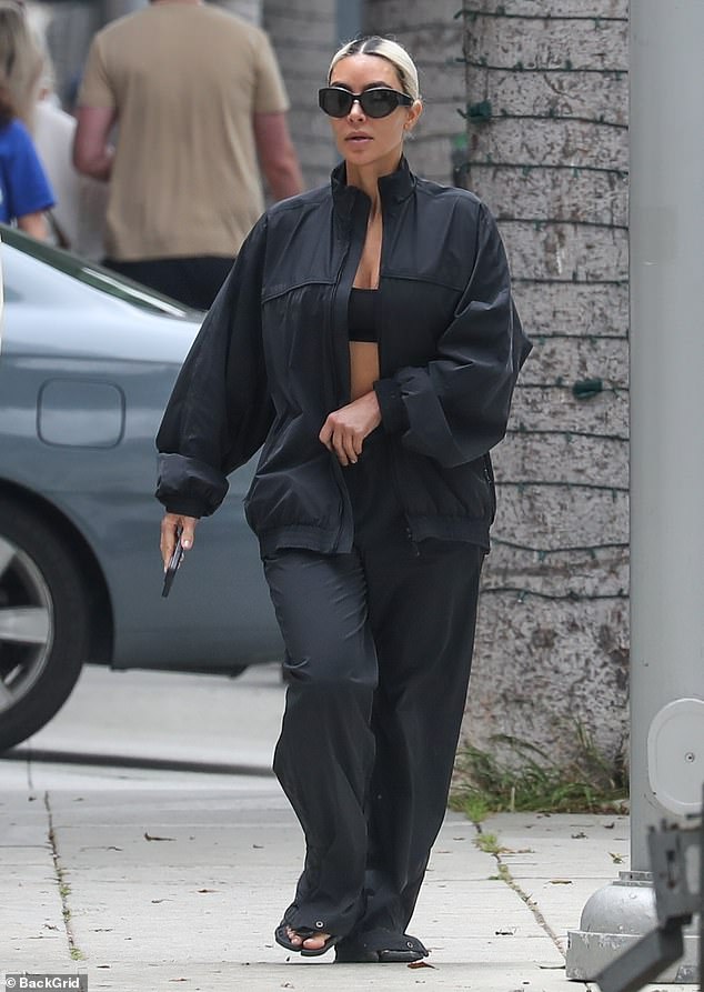 The Kardashians star was strikingly dressed in loose black sweatpants, a windbreaker and slippers