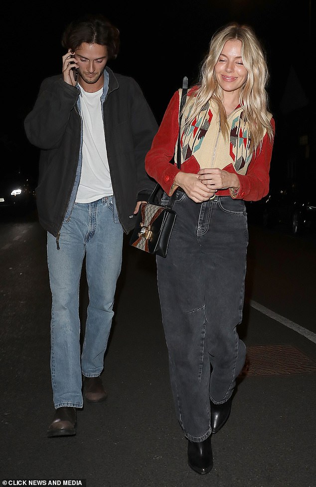 Sienna looked boho chic in carrot-bone jeans and an embroidered red jacket