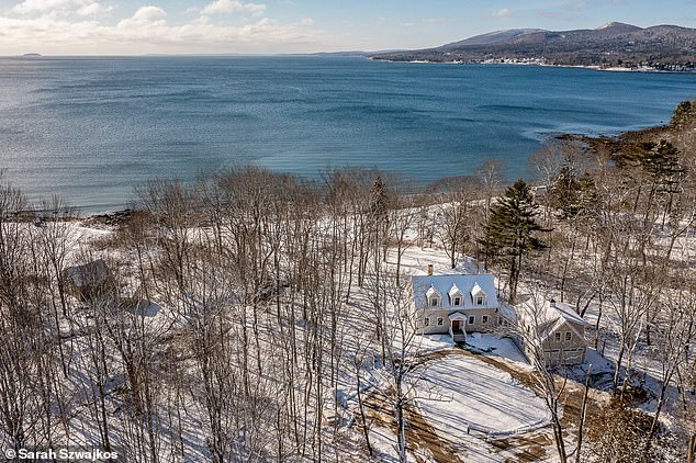 The house is located near a private beach with 350 feet of ocean and spectacular views of two islands: Camden Hills and Penobscot Bay.  (Pictured: the house and beach in winter)