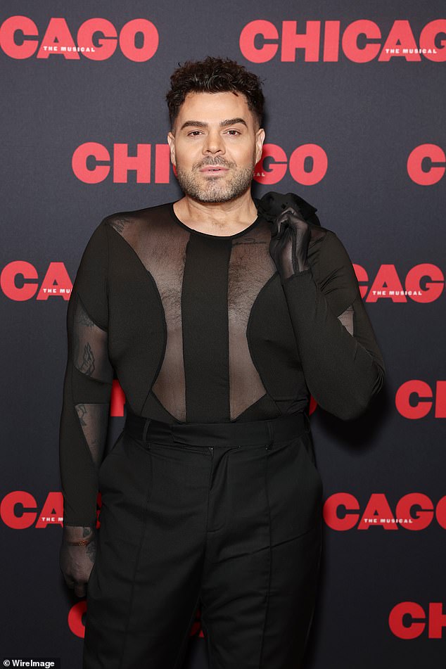 Justin Hill looked fashionable in a black ensemble with a sheer cut-out top