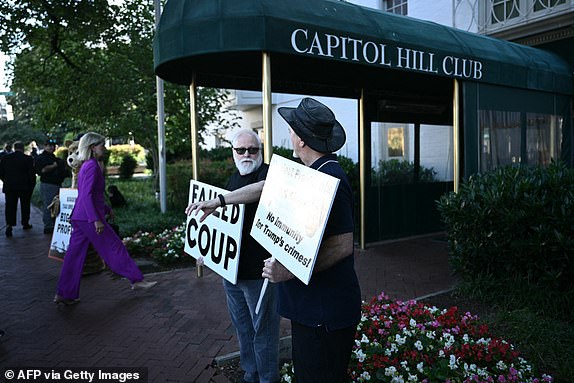 Protesters demonstrate before US former president and Republican presidential candidate Donald Trump meets House and Senate Republicans on Capitol Hill in Washington, DC on June 12, 2024.  (Photo by Brendan SMIALOWSKI/AFP) (Photo by BRENDAN SMIALOWSKI/AFP via Getty Images)