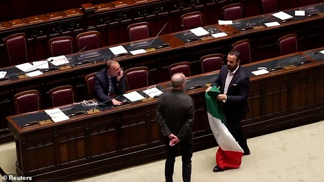 Video of the clash on Wednesday showed politicians gathering with Leonardo Donno, of the Five Star Movement, who tried to unfurl an Italian flag in front of Roberto Calderoli