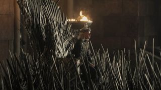 King Aegon II listens to some peasants off camera while sitting on the Iron Throne in Season 2 of House of the Dragon