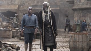Alyn van Hull walks into a harbor with Corlys Velaryon in season 2 of House of the Dragon