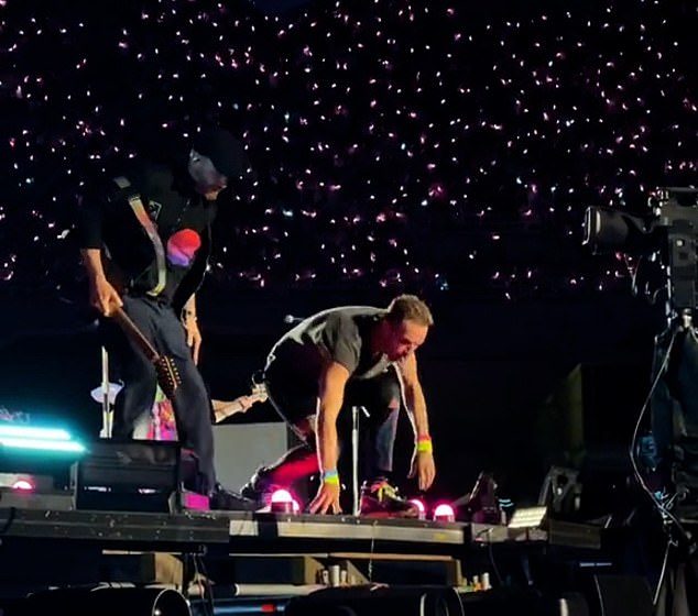 Martin and guitarist Johnny Buckland were seen running to the edge of the set, where they looked down at the person desperate to take the stage as crew members and security swarmed the stage.