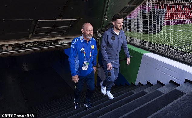 Robertson and boss Clarke emerge from the Allianz Arena tunnel