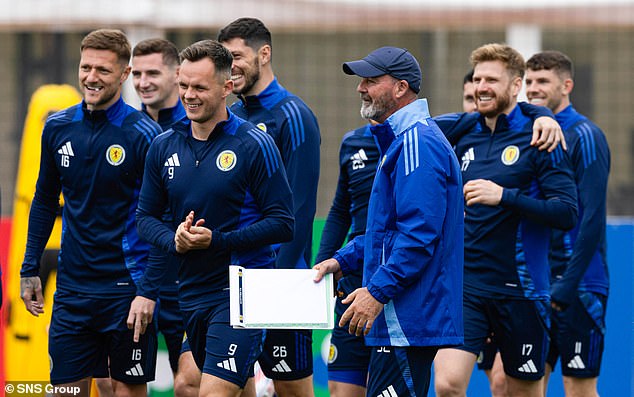 Clarke shares a joke with his players during the countdown to the match against Germany